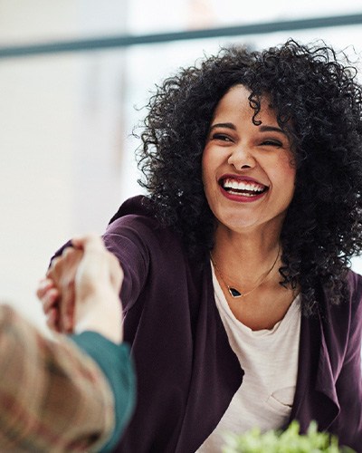 Female professional smiling while wearing Invisalign in Mississauga
