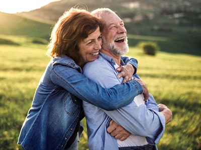 Man and woman embracing in a field