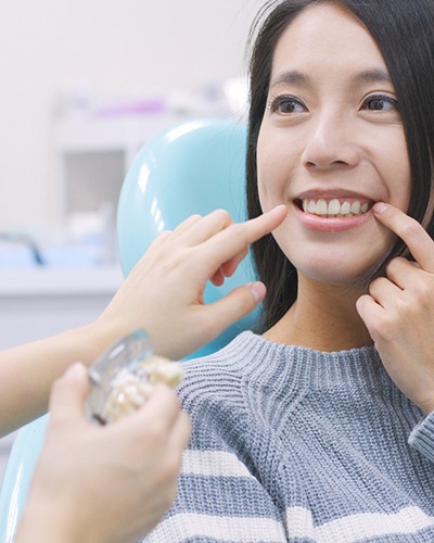 A woman pointing to her tooth